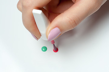 Image showing woman's hand with a brush of nail polish