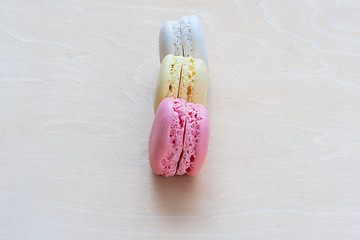 Image showing Colorful macaroons on wooden background