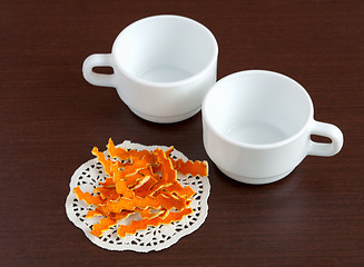 Image showing Dried orange peels and cups