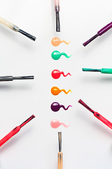 Image showing Set of multicolored nail polish brushes and drops