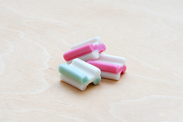 Image showing tasty bubble gum on white wooden background