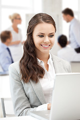 Image showing businesswoman with laptop computer at work