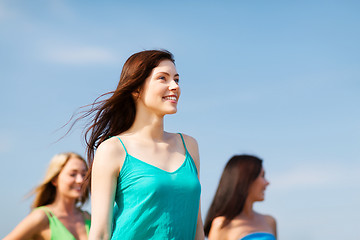 Image showing girl with friends walking on the beach