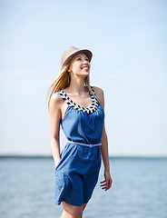 Image showing girl in hat walking on the beach