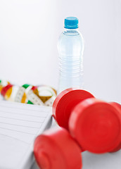 Image showing scales, dumbbells, bottle of water, measuring tape