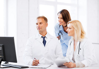 Image showing doctors looking at computer on meeting