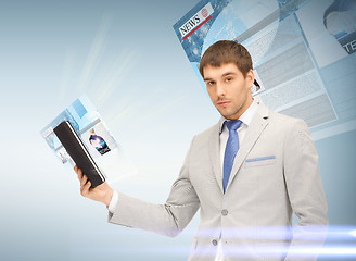 Image showing businessman with tablet pc reading news