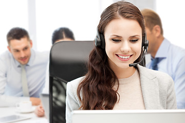 Image showing helpline operator with headphones in call centre