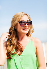 Image showing girl in shades in cafe on the beach