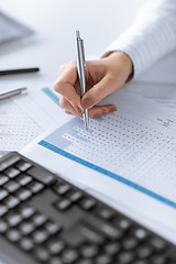 Image showing woman hand writing on paper with numbers