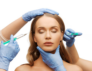 Image showing woman face and beautician hands with syringe