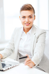 Image showing businesswoman with laptop using credit card
