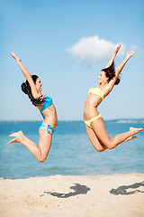 Image showing girls jumping on the beach