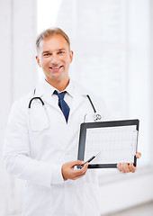 Image showing male doctor with stethoscope showing cardiogram