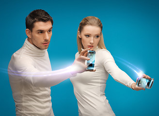 Image showing futuristic man and woman working with gadgets