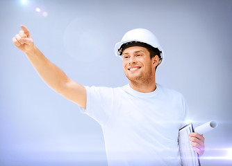 Image showing male architect in helmet with blueprint