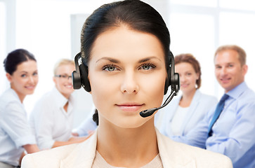 Image showing helpline operator with headphones in call centre