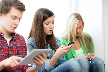 Image showing students looking into devices at school