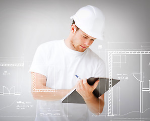 Image showing male architect looking at blueprint