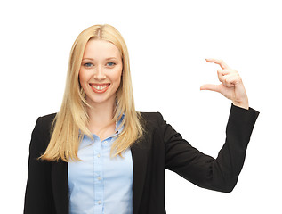 Image showing businesswoman holding something imaginary