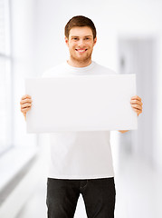 Image showing young man holding white blank board