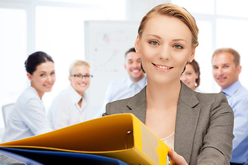 Image showing woman with folders in office