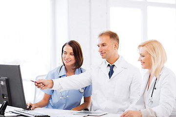 Image showing doctors looking at computer on meeting