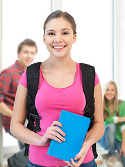 Image showing smiling student with book and school bag