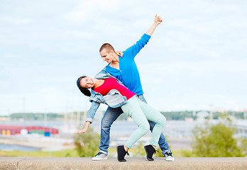 Image showing couple of teenagers dancing outside