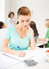 Image showing student girl with notebook and calculator