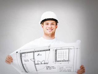 Image showing male architect in helmet with blueprint