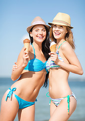 Image showing girls in bikinis with ice cream on the beach