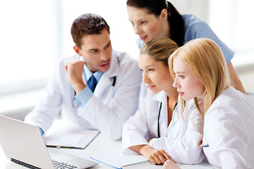 Image showing group of doctors looking at tablet pc