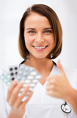 Image showing doctor with blister packs of pills