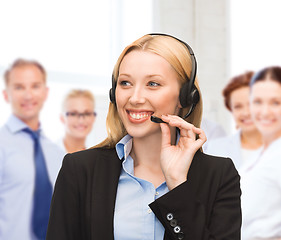 Image showing helpline operator with headphones in call centre