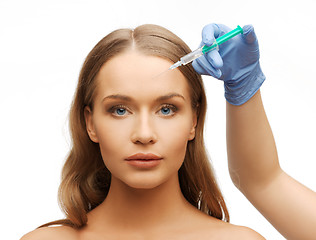 Image showing woman face and beautician hands with syringe