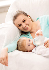 Image showing mother and adorable baby with feeding-bottle