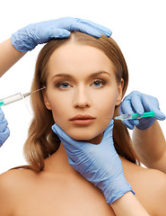 Image showing woman face and beautician hands with syringe