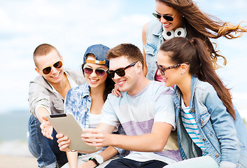 Image showing group of teenagers looking at tablet pc