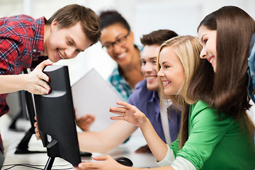 Image showing students looking at computer monitor at school