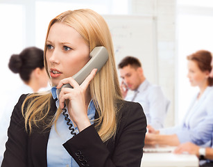 Image showing confused woman with phone