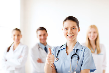 Image showing doctor with group of medics showing thumbs up