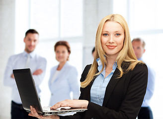 Image showing businesswoman with laptop computer at work