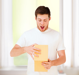 Image showing man in white t-shirt with gift box