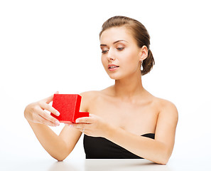 Image showing woman with earrings, wedding ring and gift box