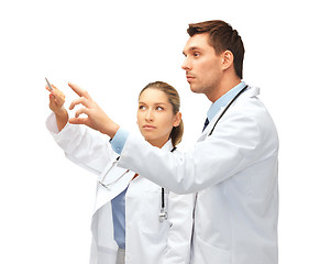 Image showing young doctors working with something imaginary