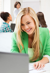Image showing student girl with laptop in college