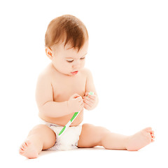 Image showing curious baby brushing teeth