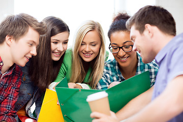 Image showing students looking at notebook at school