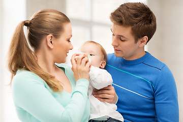 Image showing family and adorable baby with feeding-bottle